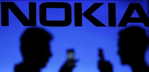 A photo illustration of men silhouetted against a Nokia logo in the central Bosnian town of Zenica January 23, 2014. REUTERS/Dado Ruvic A photo illustration of men silhouetted against a Nokia logo in the central Bosnian town of Zenica January 23, 2014. REUTERS/Dado Ruvic