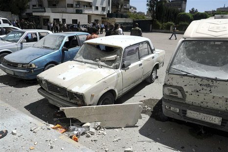 Damaged vehicles are seen after mortar bombs landed on two areas in Damascus April 29, 2014, in this handout photograph released by Syria's Damaged vehicles are seen after mortar bombs landed on two areas in Damascus April 29, 2014, in this handout photograph released by Syria's