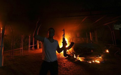 A protester reacts as the U.S. Consulate in Benghazi is seen in flames during a protest by an armed group said to have been protesting a fil A protester reacts as the U.S. Consulate in Benghazi is seen in flames during a protest by an armed group said to have been protesting a fil