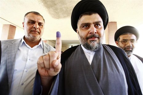 Shiite cleric Moqtada al-Sadr shows his ink-stained finger at a polling station during parliamentary election in Najaf, south of Baghdad Apr Shiite cleric Moqtada al-Sadr shows his ink-stained finger at a polling station during parliamentary election in Najaf, south of Baghdad Apr