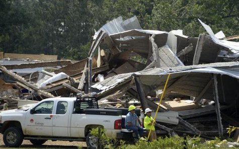 Power line crew work around collapsed buildings after a tornado hit Pearl, Mississippi April 29, 2014.
CREDIT: REUTERS/GENE BLEVINS Power line crew work around collapsed buildings after a tornado hit Pearl, Mississippi April 29, 2014.
CREDIT: REUTERS/GENE BLEVINS