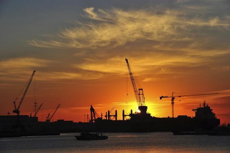 A shipyard is silhouetted against the rising sun in Dalian, Liaoning province, Janaury 28, 2014. REUTERS/China Daily A shipyard is silhouetted against the rising sun in Dalian, Liaoning province, Janaury 28, 2014. REUTERS/China Daily