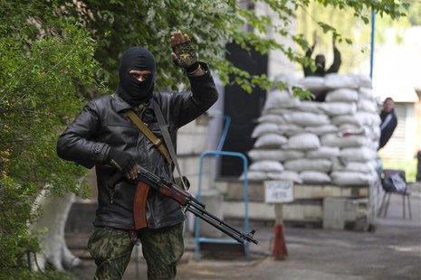 A pro-Russian armed man waves to participants of an International Worker's Day, or Labour Day, parade in the town of Slaviansk, east Ukraine A pro-Russian armed man waves to participants of an International Worker's Day, or Labour Day, parade in the town of Slaviansk, east Ukraine