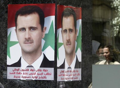 Posters of Syrian President Bashar al-Assad placed by pro-Assad group "Qasion Forum", calling for him to run for a third term, are seen at a Posters of Syrian President Bashar al-Assad placed by pro-Assad group "Qasion Forum", calling for him to run for a third term, are seen at a