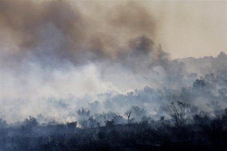 Smoke rises from a charred landscape as a wildfire driven by fierce Santa Ana winds spreads in Rancho Cucamonga, California, April 30, 2014. Smoke rises from a charred landscape as a wildfire driven by fierce Santa Ana winds spreads in Rancho Cucamonga, California, April 30, 2014.
