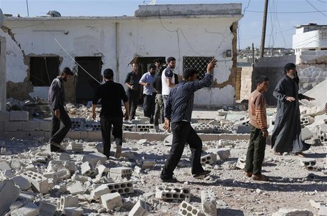 People inspect a site hit by what activists said were barrel bombs dropped by forces loyal to Syria's President Bashar al-Assad in al-Letman People inspect a site hit by what activists said were barrel bombs dropped by forces loyal to Syria's President Bashar al-Assad in al-Letman
