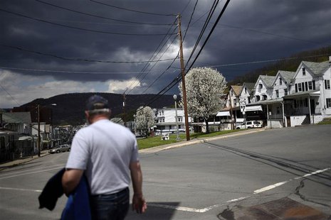 A man walks down Market Street with darkening clouds forming above the bluff in the distance in Shamokin May 1, 2014. REUTERS/Mark Makela A man walks down Market Street with darkening clouds forming above the bluff in the distance in Shamokin May 1, 2014. REUTERS/Mark Makela