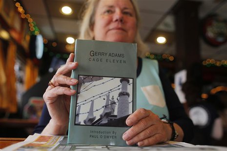 Peggy Kelly, owner of Murphy's Law pub, poses for a photograph with a book by Sinn Fein leader Gerry Adams in the South Boston neighborhood Peggy Kelly, owner of Murphy's Law pub, poses for a photograph with a book by Sinn Fein leader Gerry Adams in the South Boston neighborhood