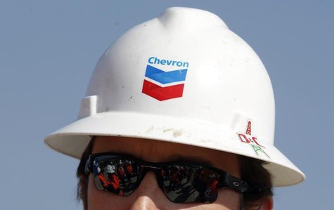Journalists are reflected in the sunglasses of drilling site manager Greg Murphy during a media day at Chevron's site in Pungesti April 8, 2 Journalists are reflected in the sunglasses of drilling site manager Greg Murphy during a media day at Chevron's site in Pungesti April 8, 2