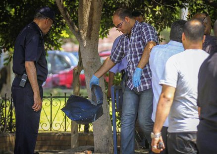 Egyptian security officials inspect a site hit by a bomb attack targeting a traffic security post near a court house in Cairo's Heliopolis d Egyptian security officials inspect a site hit by a bomb attack targeting a traffic security post near a court house in Cairo's Heliopolis d