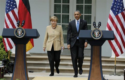 U.S. President Barack Obama and German Chancellor Angela Merkel arrive for a joint news conference in the Rose Garden of the White House in U.S. President Barack Obama and German Chancellor Angela Merkel arrive for a joint news conference in the Rose Garden of the White House in