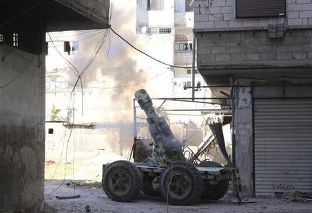 Rebel fighters fire an artillery cannon towards forces loyal to Syria's President Bashar al-Assad in eastern al-Ghouta, near Damascus April Rebel fighters fire an artillery cannon towards forces loyal to Syria's President Bashar al-Assad in eastern al-Ghouta, near Damascus April