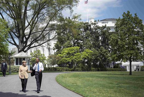 U.S. President Barack Obama (R) and German Chancellor Angela Merkel walk following their meeting to the herb and vegetable garden of the Whi U.S. President Barack Obama (R) and German Chancellor Angela Merkel walk following their meeting to the herb and vegetable garden of the Whi