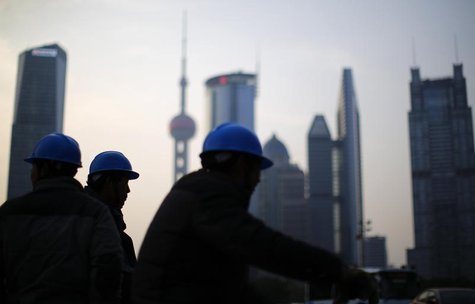 Construction workers stand on a street corner at the financial district of Pudong in Shanghai March 11, 2014. REUTERS/Carlos Barria Construction workers stand on a street corner at the financial district of Pudong in Shanghai March 11, 2014. REUTERS/Carlos Barria