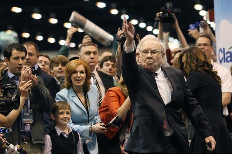 Berkshire Hathaway CEO Warren Buffett throws a newspaper during a competition at a trade show, at the company's annual meeting in Omaha, Neb Berkshire Hathaway CEO Warren Buffett throws a newspaper during a competition at a trade show, at the company's annual meeting in Omaha, Neb