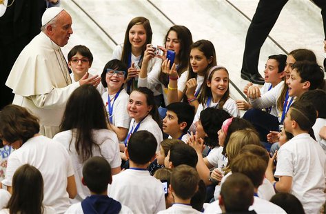 Pope Francis talks with children during a special audience with members of the "Catholic Action" in Paul VI hall at the Vatican May 3, 2014. Pope Francis talks with children during a special audience with members of the "Catholic Action" in Paul VI hall at the Vatican May 3, 2014.