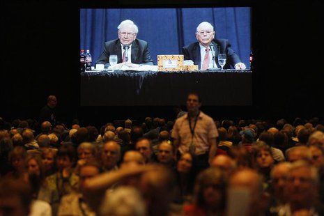 Berkshire Hathaway shareholders listen to CEO Warren Buffett and vice-chairman Charlie Munger seen on a projection screen in the background Berkshire Hathaway shareholders listen to CEO Warren Buffett and vice-chairman Charlie Munger seen on a projection screen in the background