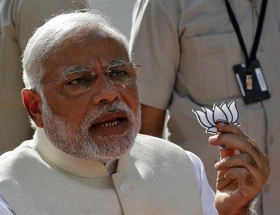 Hindu nationalist Narendra Modi, the prime ministerial candidate for India's main opposition Bharatiya Janata Party (BJP), holds a lotus cut Hindu nationalist Narendra Modi, the prime ministerial candidate for India's main opposition Bharatiya Janata Party (BJP), holds a lotus cut