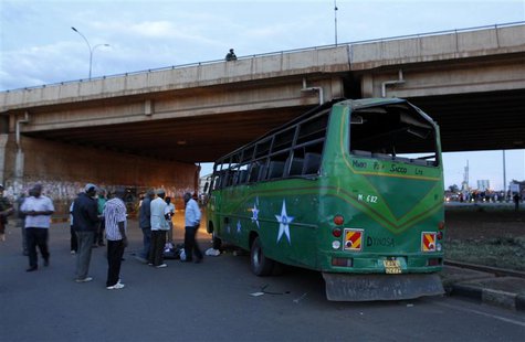 Bomb experts and plain clothes policemen gather at the scene of a bus explosion along the Thika super-highway in Kenya's capital Nairobi, Ma Bomb experts and plain clothes policemen gather at the scene of a bus explosion along the Thika super-highway in Kenya's capital Nairobi, Ma