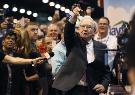 Berkshire Hathaway CEO Warren Buffett points after throwing a newspaper during a competition at a trade show, at the company's annual meetin Berkshire Hathaway CEO Warren Buffett points after throwing a newspaper during a competition at a trade show, at the company's annual meetin