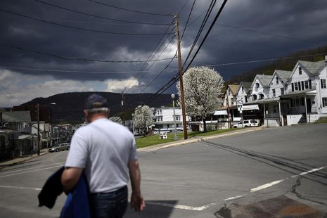 A man walks down Market Street with darkening clouds forming above the bluff in the distance in Shamokin May 1, 2014. REUTERS/Mark Makela A man walks down Market Street with darkening clouds forming above the bluff in the distance in Shamokin May 1, 2014. REUTERS/Mark Makela