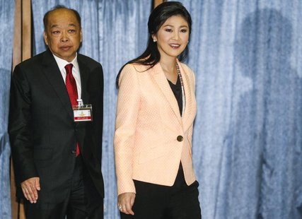 Thailand's Prime Minister Yingluck Shinawatra (R) and Deputy Prime Minister Surapong Tovichakchaikul arrive before a meeting with the Electi Thailand's Prime Minister Yingluck Shinawatra (R) and Deputy Prime Minister Surapong Tovichakchaikul arrive before a meeting with the Electi