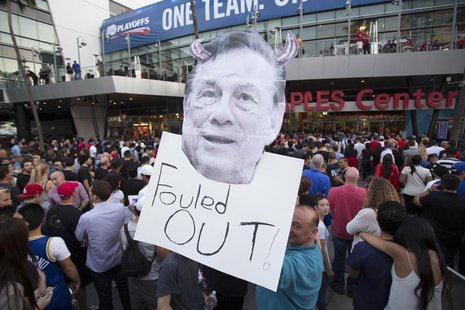 A supporter holds a photo cutout of Los Angeles Clippers owner Donald Sterling while standing in line for the NBA Playoff game 5 between Gol A supporter holds a photo cutout of Los Angeles Clippers owner Donald Sterling while standing in line for the NBA Playoff game 5 between Gol