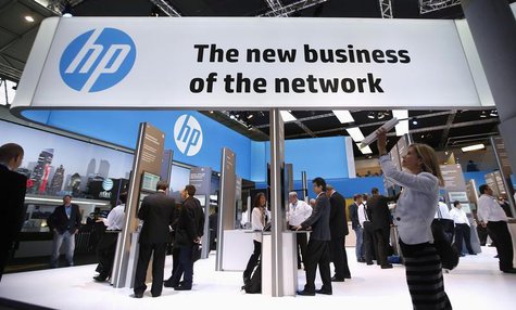 A visitor takes a photo with a tablet in front of a Hewlett-Packard (HP) stand at the Mobile World Congress in Barcelona, February 27, 2014. A visitor takes a photo with a tablet in front of a Hewlett-Packard (HP) stand at the Mobile World Congress in Barcelona, February 27, 2014.