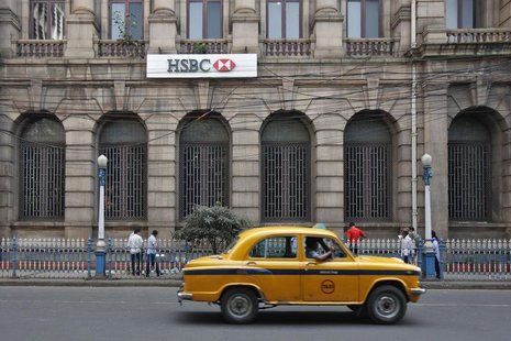 A yellow ambassador taxi drives past the HSBC bank building in Kolkata November 5, 2013. REUTERS/Rupak De Chowdhuri A yellow ambassador taxi drives past the HSBC bank building in Kolkata November 5, 2013. REUTERS/Rupak De Chowdhuri