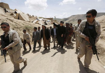 Afghan President Hamid Karzai (C) arrives at the site of a deadly landslide in the Argo district of Badakhshan province May 7, 2014. REUTERS Afghan President Hamid Karzai (C) arrives at the site of a deadly landslide in the Argo district of Badakhshan province May 7, 2014. REUTERS