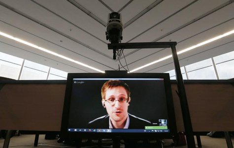 Accused government whistleblower Edward Snowden is seen on a screen as he speaks via video conference with members of the Committee on legal Accused government whistleblower Edward Snowden is seen on a screen as he speaks via video conference with members of the Committee on legal