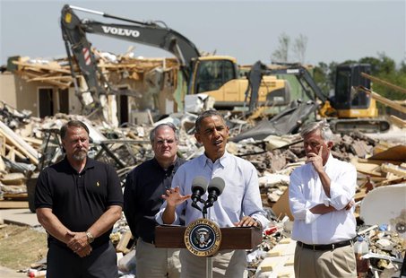 Amid the wreckage, U.S. President Barack Obama speaks as he visits the tornado devastated town of Vilonia, Arkansas May 7, 2014. With Obama Amid the wreckage, U.S. President Barack Obama speaks as he visits the tornado devastated town of Vilonia, Arkansas May 7, 2014. With Obama