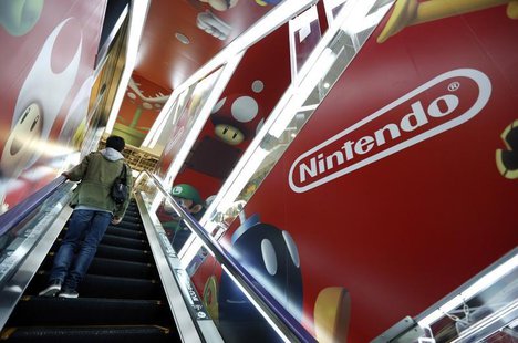 A man rides an escalator past Nintendo Co advertisements at an electronics retail store in Tokyo May 7, 2014. REUTERS/Toru Hanai A man rides an escalator past Nintendo Co advertisements at an electronics retail store in Tokyo May 7, 2014. REUTERS/Toru Hanai