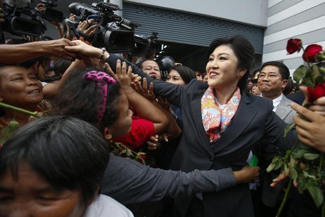 Thailand's Prime Minister Yingluck Shinawatra greets her supporters as she leaves the Permanent Secretary of Defence office in Bangkok May 7 Thailand's Prime Minister Yingluck Shinawatra greets her supporters as she leaves the Permanent Secretary of Defence office in Bangkok May 7