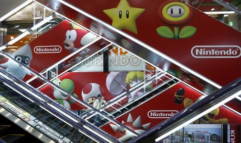 A man rides an escalator past Nintendo Co advertisements at an electronics retail store in Tokyo May 7, 2014. REUTERS/Toru Hanai A man rides an escalator past Nintendo Co advertisements at an electronics retail store in Tokyo May 7, 2014. REUTERS/Toru Hanai