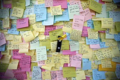 A yellow ribbon dedicated to missing and dead passengers of sunken passenger ship Sewol is seen among messages written for the victims outsi A yellow ribbon dedicated to missing and dead passengers of sunken passenger ship Sewol is seen among messages written for the victims outsi