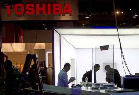 Technicians with TCL Communication put together a display near the Toshiba booth in preparation for the 2014 Consumer Electronics Show (CES) Technicians with TCL Communication put together a display near the Toshiba booth in preparation for the 2014 Consumer Electronics Show (CES)