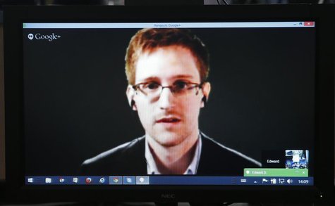 Accused government whistleblower Edward Snowden is seen on a screen as he speaks via video conference with members of the Committee on legal Accused government whistleblower Edward Snowden is seen on a screen as he speaks via video conference with members of the Committee on legal