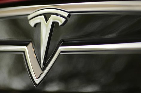 A Tesla Motors logo is shown on a Tesla Model S at a Tesla Motors dealership at Corte Madera Village, an outdoor retail mall, in Corte Mader A Tesla Motors logo is shown on a Tesla Model S at a Tesla Motors dealership at Corte Madera Village, an outdoor retail mall, in Corte Mader