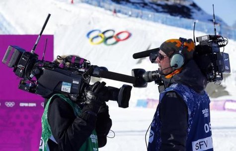 Media cameramen shouldering video cameras chat during the women's snowboard slopestyle qualifying round at the 2014 Sochi Olympic Games in Rosa Khutor February 6, 2014.
CREDIT: REUTERS/MIKE BLAKE Media cameramen shouldering video cameras chat during the women's snowboard slopestyle qualifying round at the 2014 Sochi Olympic Games in Rosa Khutor February 6, 2014.
CREDIT: REUTERS/MIKE BLAKE