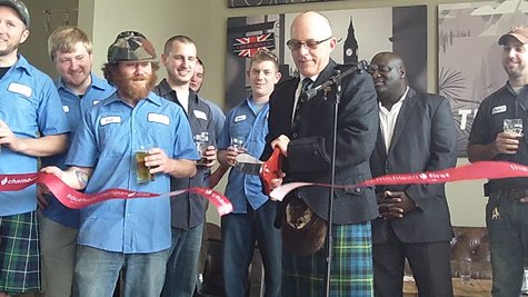 Tim Suprise uses a giant pair of scissors to snip the ribbon. Yes he is wearing a kilt. Tim Suprise uses a giant pair of scissors to snip the ribbon. Yes he is wearing a kilt.