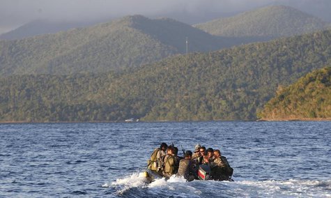 Members of the Philippine marines are transported on a rubber boat from a patrol ship after conducting a mission on the disputed Second Thom Members of the Philippine marines are transported on a rubber boat from a patrol ship after conducting a mission on the disputed Second Thom