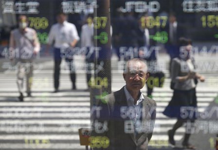 People are reflected on a stock quotation board outside a brokerage in Tokyo May 7, 2014. REUTERS/Toru Hanai People are reflected on a stock quotation board outside a brokerage in Tokyo May 7, 2014. REUTERS/Toru Hanai