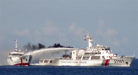 A Chinese ship (R) uses water cannon on a Vietnamese Sea Guard ship on the South China Sea near the Paracels islands, in this handout photo A Chinese ship (R) uses water cannon on a Vietnamese Sea Guard ship on the South China Sea near the Paracels islands, in this handout photo