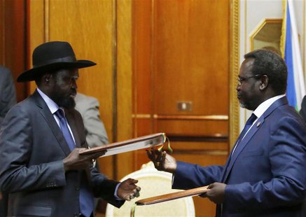 South Sudan's rebel leader Riek Machar (R) and South Sudan's President Salva Kiir (L) exchange signed peace agreement documents in Addis Aba South Sudan's rebel leader Riek Machar (R) and South Sudan's President Salva Kiir (L) exchange signed peace agreement documents in Addis Aba