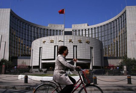 A woman rides past the headquarters of the People's Bank of China, the Chinese central bank, in Beijing, April 3, 2014. REUTERS/Petar Kujund A woman rides past the headquarters of the People's Bank of China, the Chinese central bank, in Beijing, April 3, 2014. REUTERS/Petar Kujund