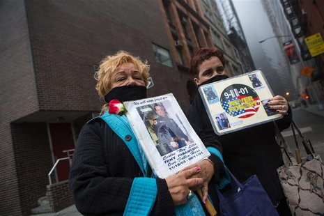 Family members of victims of the September 11 attacks hold signs while demonstrating against the decision to transfer the 9/11 unidentified Family members of victims of the September 11 attacks hold signs while demonstrating against the decision to transfer the 9/11 unidentified