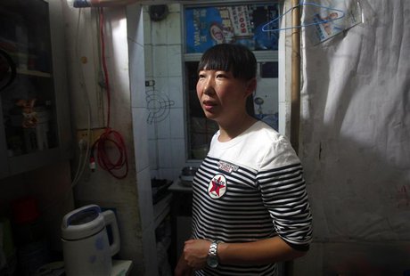 Wang Yafang stands inside her one-bedroom apartment in Shenzhen, Guangdong province April 17, 2014. REUTERS/John Ruwitch Wang Yafang stands inside her one-bedroom apartment in Shenzhen, Guangdong province April 17, 2014. REUTERS/John Ruwitch