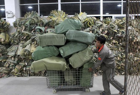 A worker pushes a cart filled with packages at a logistics hub in Fuzhou, Fujian province November 13, 2012. REUTERS/Stringer A worker pushes a cart filled with packages at a logistics hub in Fuzhou, Fujian province November 13, 2012. REUTERS/Stringer