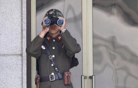 A bruise is seen on the right hand of a North Korean soldier observing activities in the south of the truce village of Panmunjom in the demi A bruise is seen on the right hand of a North Korean soldier observing activities in the south of the truce village of Panmunjom in the demi